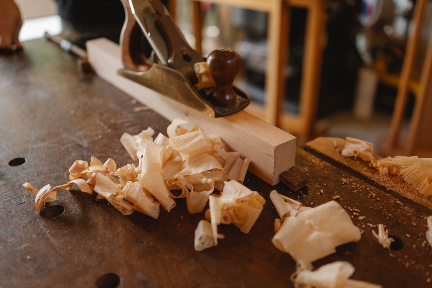 Jack plane and fresh shavings on a workbench