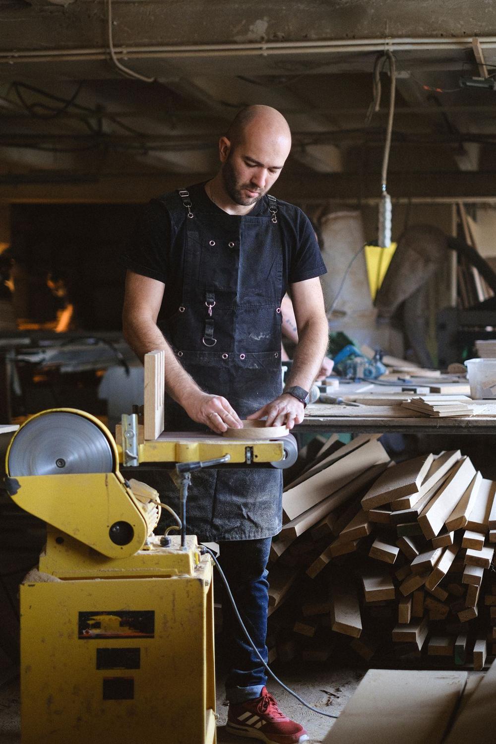 A joiner shaping a component at the bench