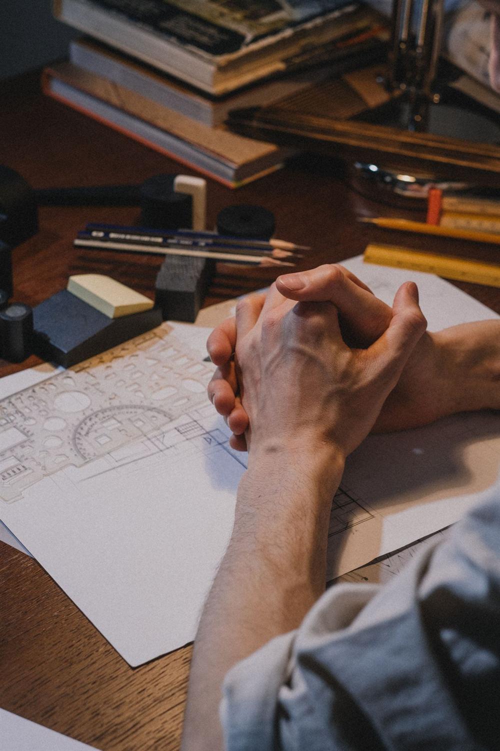Hands over a set of shop drawings