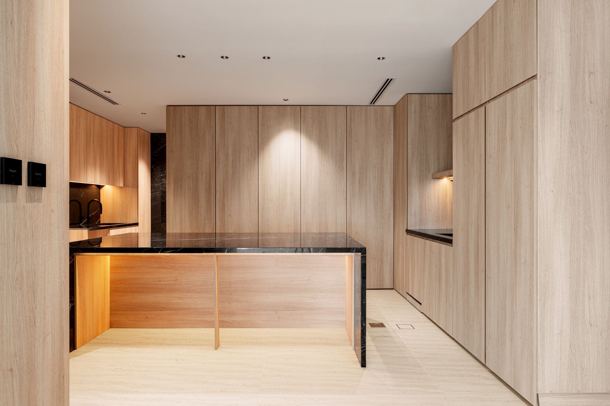 Rift-sawn white oak kitchen with a honed black stone island