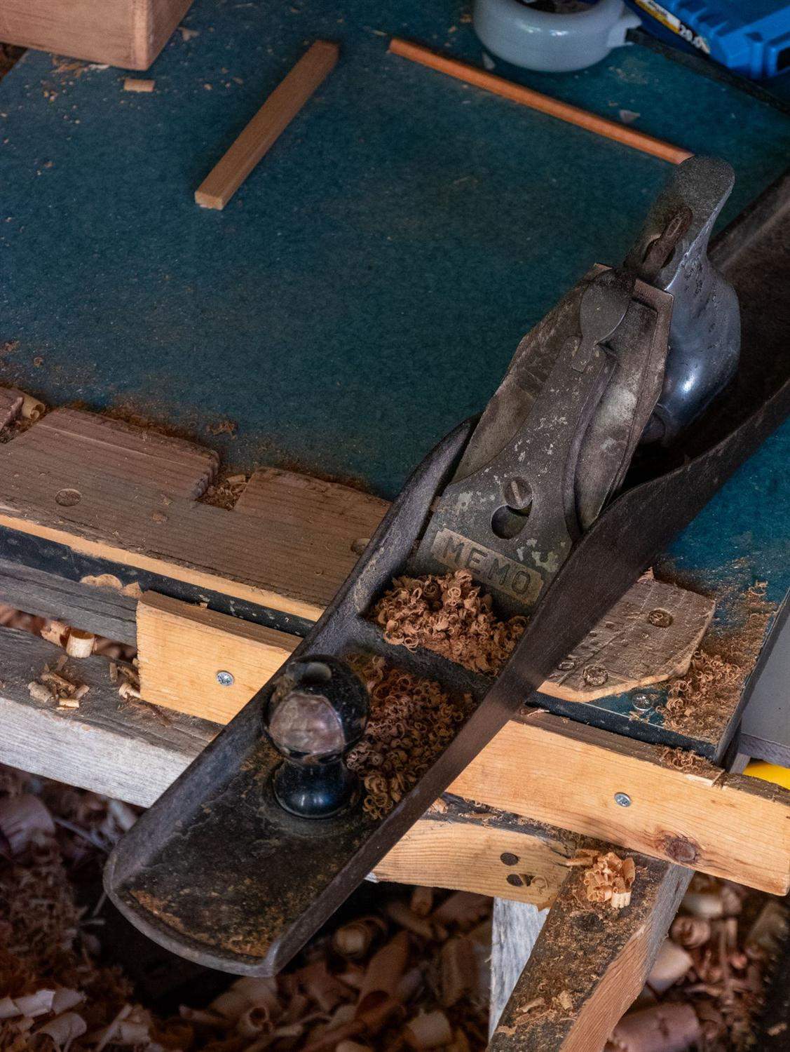 A jack plane resting on a workbench